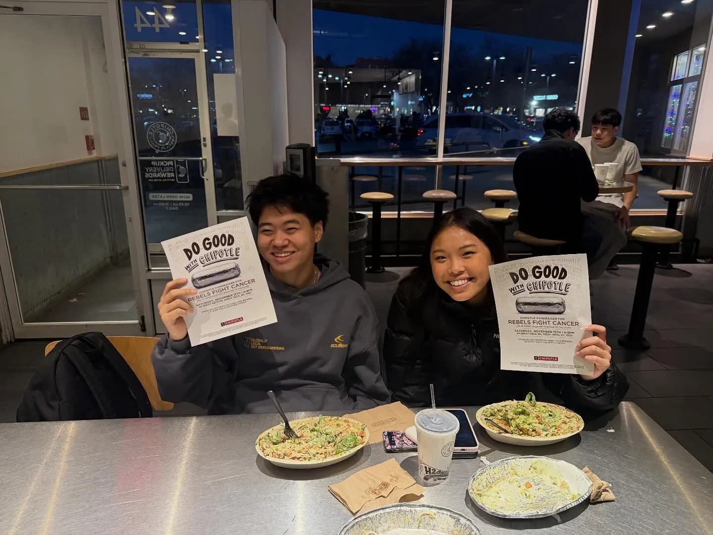 Diners holding fundraiser flyers