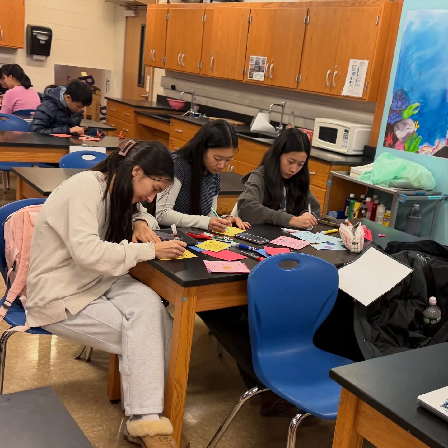 Students writing cards at lab tables