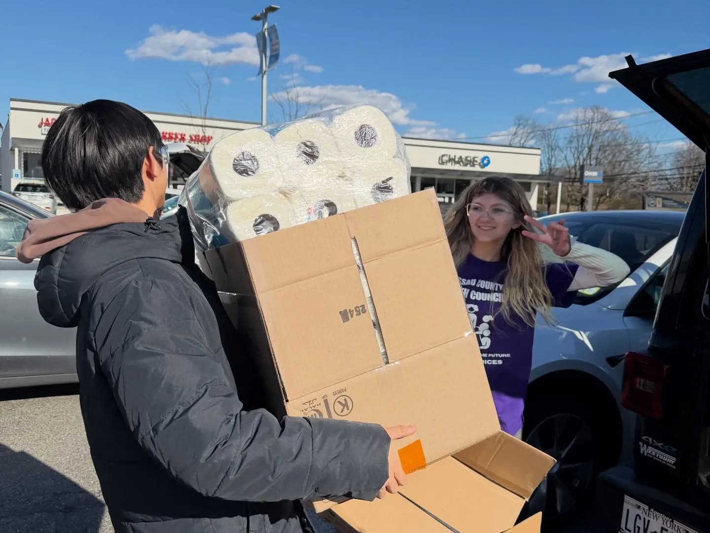 Loading donated supplies into a car