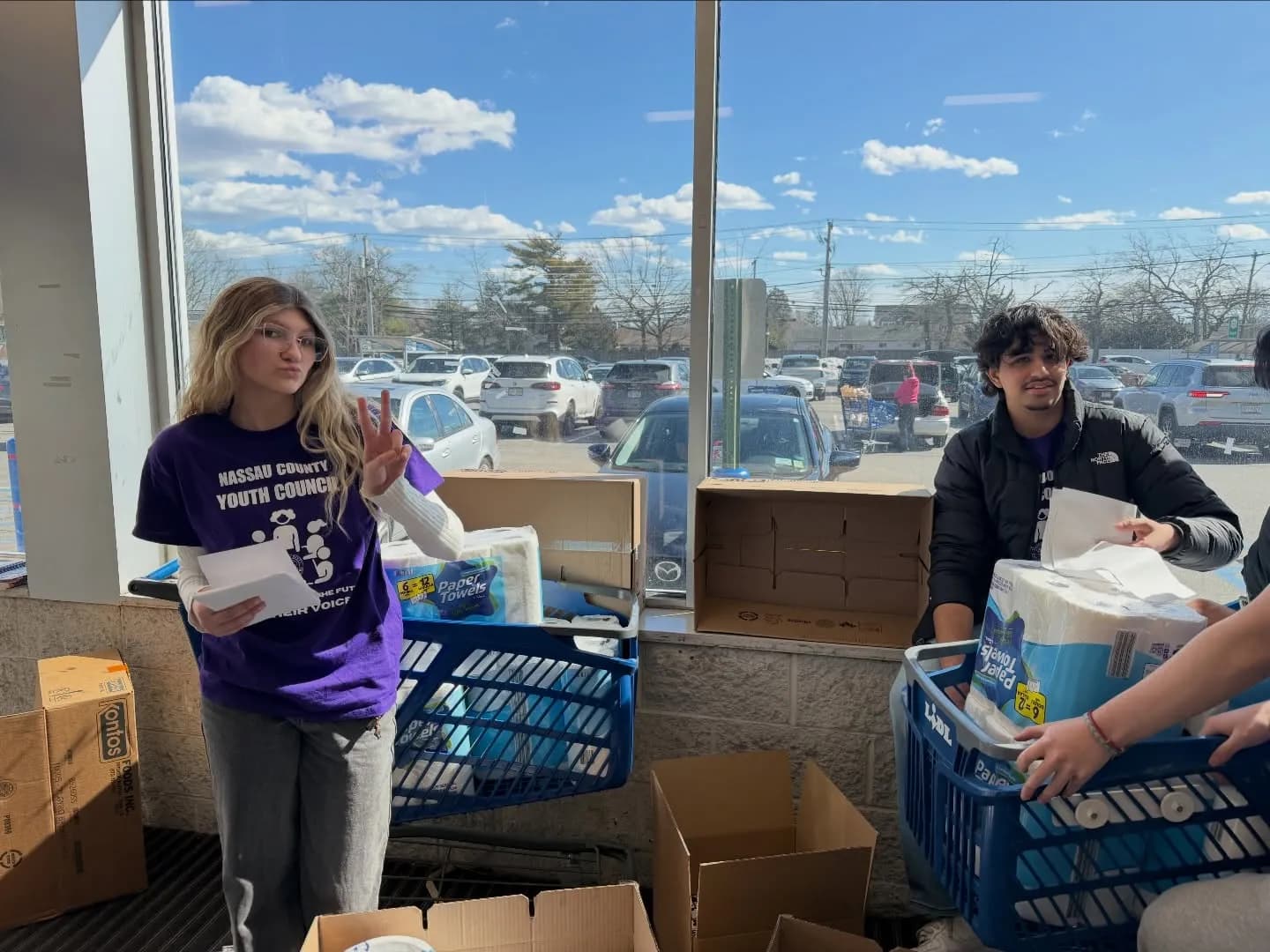 A volunteer with a cart of donations