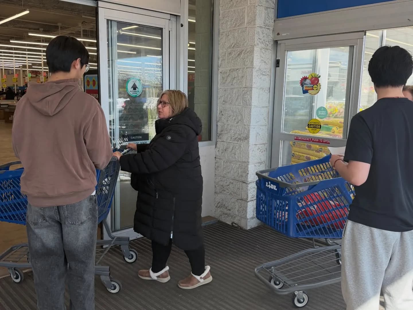 Volunteers loading carts with a shopper